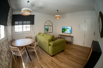 a living room with a couch and a table at Apartamentos Milord in El Puerto de Santa María