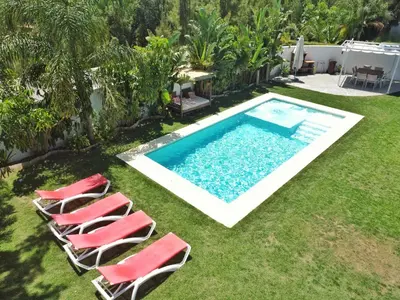 a group of chairs and a swimming pool at Villa Edén, Casa Rural lujo con Chimenea Piscina in Arcos de la Frontera