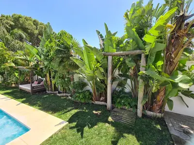 a garden with trees and a swimming pool at Villa Edén, Casa Rural lujo con Chimenea Piscina in Arcos de la Frontera