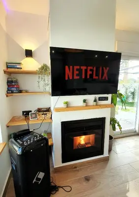 a living room with a television and a fireplace at Villa Edén, Casa Rural lujo con Chimenea Piscina in Arcos de la Frontera