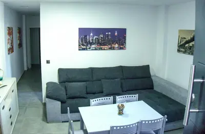 a living room with a couch and a table at Apartamento Vistas de Doñana in Sanlúcar de Barrameda