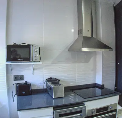 a kitchen with a microwave and a toaster oven at Apartamento Vistas de Doñana in Sanlúcar de Barrameda