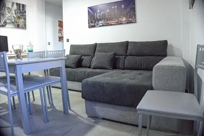 a living room with a couch and a table at Apartamento Vistas de Doñana in Sanlúcar de Barrameda