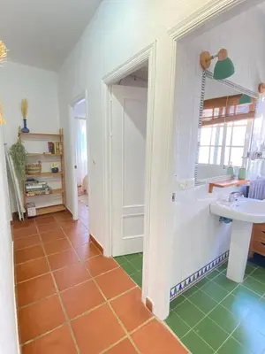 a bathroom with a white sink and a green floor at Tierra del Sur in Conil de la Frontera