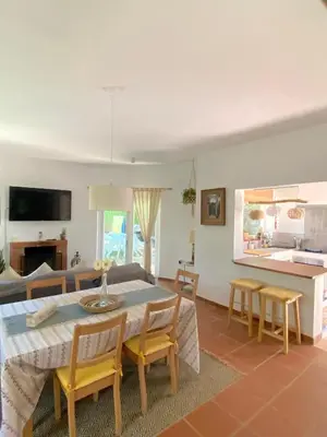 a dining room and living room with a table and chairs at Tierra del Sur in Conil de la Frontera