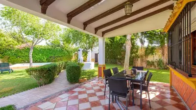 a porch with a table and chairs on a patio at Villa El Cortijo Andaluz Conil de la Frontera by Ruralidays in Conil de la Frontera