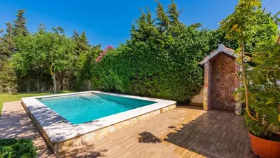 a swimming pool in a yard with a wooden deck at Villa El Cortijo Andaluz Conil de la Frontera by Ruralidays in Conil de la Frontera