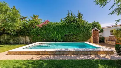 a swimming pool in the yard of a house at Villa El Cortijo Andaluz Conil de la Frontera by Ruralidays in Conil de la Frontera