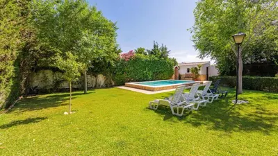 a yard with two chairs and a swimming pool at Villa El Cortijo Andaluz Conil de la Frontera by Ruralidays in Conil de la Frontera