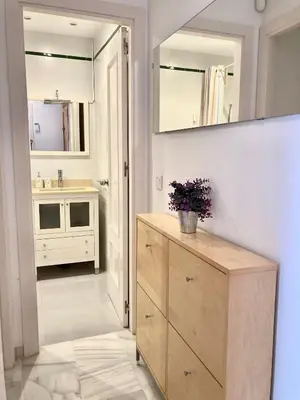a bathroom with a sink and a vanity with a mirror at APARTAMENTO GENOVEVA PLAYA - Playa, Piscina, Wifi in El Puerto de Santa María