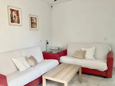 a living room with two couches and a coffee table at APARTAMENTO GENOVEVA PLAYA - Playa, Piscina, Wifi in El Puerto de Santa María