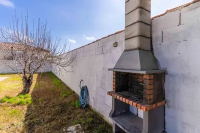 an outdoor brick oven sitting next to a wall at Casita de la coquina in Chiclana de la Frontera