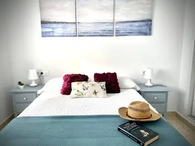 a bedroom with a bed with a hat on it at MyChoice Carmen in Rota