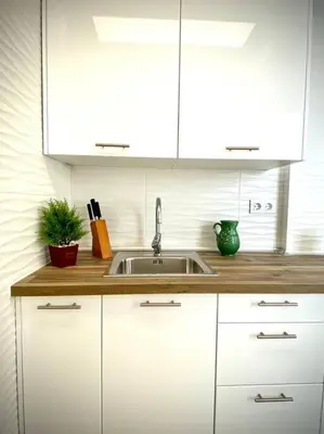 a kitchen with white cabinets and a sink at MyChoice Carmen in Rota
