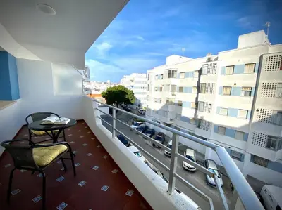 a balcony with a table and chairs on a building at MyChoice Carmen in Rota