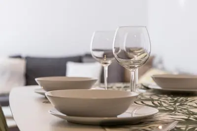 a table with bowls and wine glasses on it at Apartoyou - Luna Centro in El Puerto de Santa María