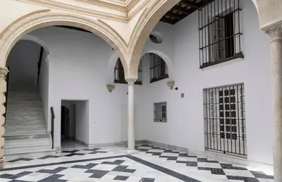 a room with white walls and black and white checkered floors at Apartoyou - Luna Centro in El Puerto de Santa María