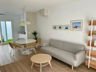 a living room with a couch and a table at Adosado en calle Nereida in Chiclana de la Frontera