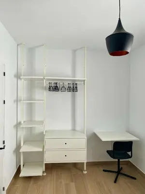 a white closet with a desk and a chair at Adosado en calle Nereida in Chiclana de la Frontera