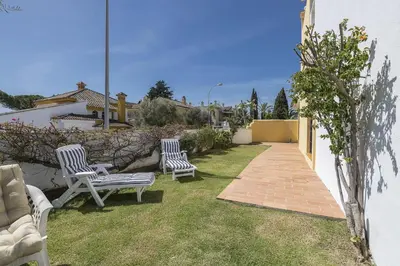 two chairs sitting on the grass in a yard at Los Jandalos in El Puerto de Santa María