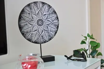 a black and white plate on top of a table at Apartamento San Leonardo Playa (Free Parking) in Cádiz