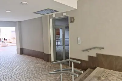 a lobby with stairs and a mirror in a building at Apartamento San Leonardo Playa (Free Parking) in Cádiz