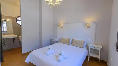 a bedroom with a white bed with two sinks on it at Cortijo Escondido Arcos de la Frontera by Ruralidays in Arcos de la Frontera