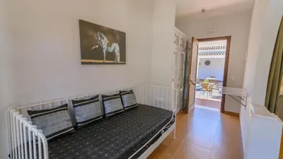 a couch in a living room with a horse picture on the wall at Cortijo Escondido Arcos de la Frontera by Ruralidays in Arcos de la Frontera