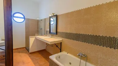 a bathroom with a tub and a sink and a bath tub at Cortijo Escondido Arcos de la Frontera by Ruralidays in Arcos de la Frontera