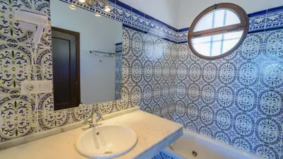 a bathroom with blue and white tiled walls and a sink at Cortijo Escondido Arcos de la Frontera by Ruralidays in Arcos de la Frontera