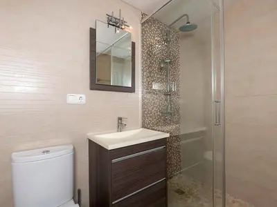 a bathroom with a toilet and a sink and a shower at Apartment Punta Candor - Seaview by Interhome in Rota