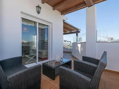 a patio with chairs and a table on a balcony at Apartment Punta Candor - Seaview by Interhome in Rota