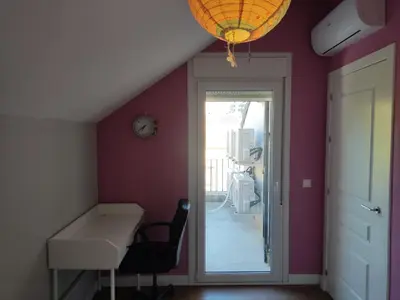 a room with a desk and a table and a door at Chalet con piscina in San Fernando