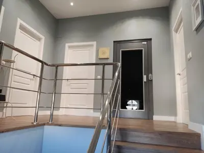 a staircase with a glass railing in a house at Chalet con piscina in San Fernando