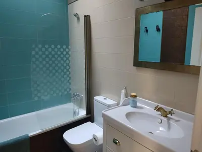 a bathroom with a sink and a toilet and a shower at Chalet con piscina in San Fernando
