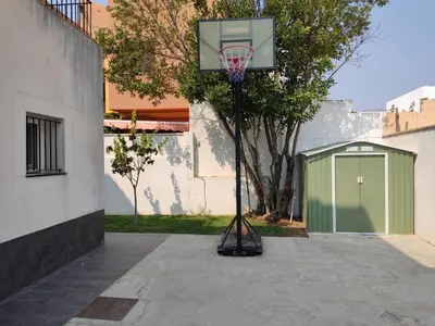 a basketball hoop in front of a building at Chalet con piscina in San Fernando