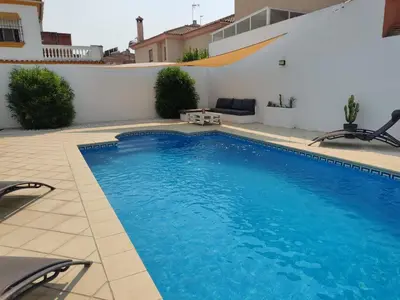 a swimming pool with blue water in a building at Chalet con piscina in San Fernando