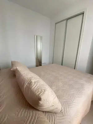 a bed with a pillow on top of it at Villa Tropical a 2 minutos del Faro de Chipiona in Chipiona