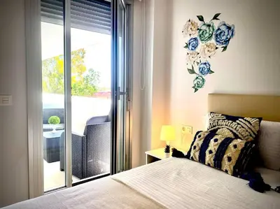 a bedroom with a bed and a view of a balcony at MyChoice Diana in Rota