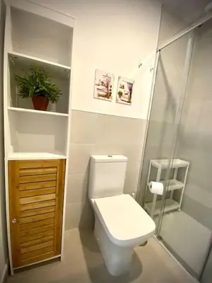 a bathroom with a toilet and a glass shower at MyChoice Diana in Rota