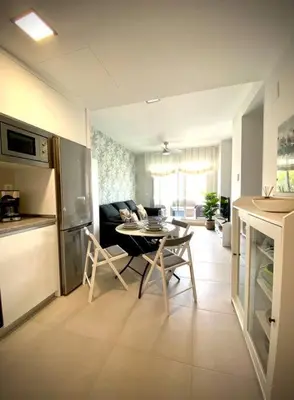 a kitchen and living room with a table and chairs at MyChoice Diana in Rota