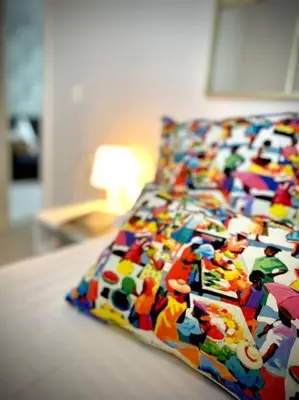 a bed with a colorful comforter on it at MyChoice Diana in Rota