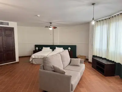 a living room with a couch and a bed at Hotel Bodegas Campestral in Arcos de la Frontera
