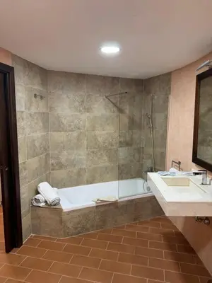 a bathroom with a tub and a sink and a shower at Hotel Bodegas Campestral in Arcos de la Frontera