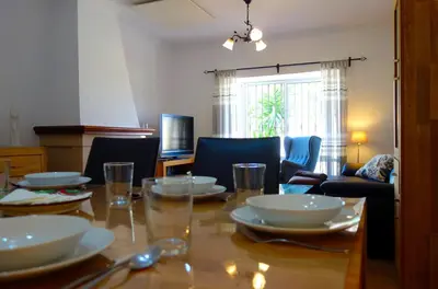 a dining room table with plates and glasses on it at HAPPY HOMES CASA LIMÓN - Premium - Pool - Klimaanlage - WLAN in Chiclana de la Frontera