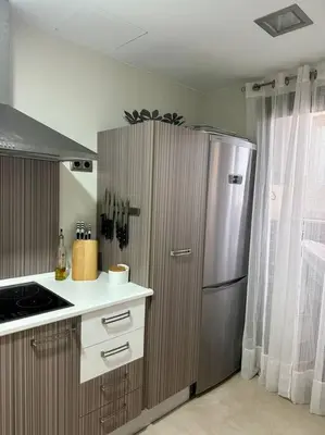 a kitchen with a stainless steel refrigerator next to a window at Villanueva Golf- Cozy 2 Bedrooms -Puerto Real, Cádiz in Puerto Real