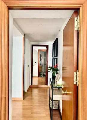 a hallway with a door open to a room with a desk at Papallona Cádiz Apartment Grupo AC Gestion in Cádiz