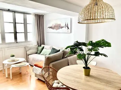 a living room with a couch and a table at Papallona Cádiz Apartment Grupo AC Gestion in Cádiz