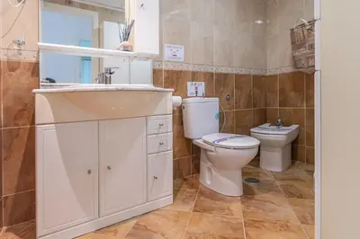 a bathroom with a sink and a toilet at Apartamento Cortadura Playa in Cádiz