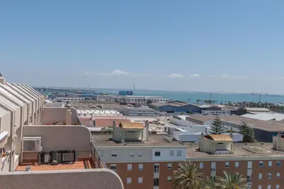 a view of a city with buildings and the ocean at Apartamento Cortadura Playa in Cádiz